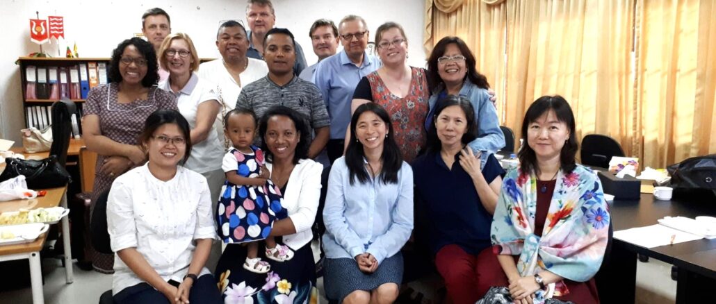 A group of people posing for a photo Description automatically generated